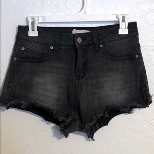 Faded black cutoff shorts.
